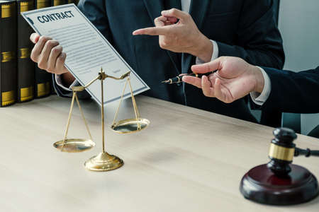 hand holding pen, the lawyer providing legal consult business dispute service at the office with...