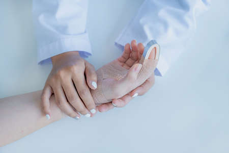 The doctor hands holding patient in arm accident to encourage and explained the health examination...