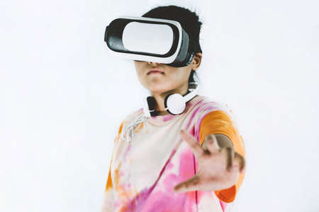 Asian girl excited about VR Box experience, virtual reality technology on white background.の写真素材