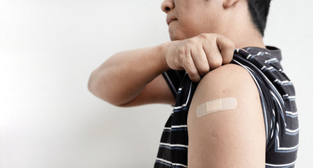 Asia man showing shoulder with bandageの写真素材