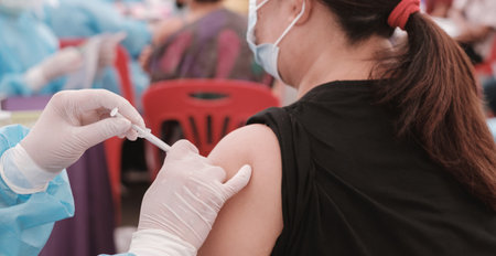 medical doctor giving vaccine to senior womanの写真素材
