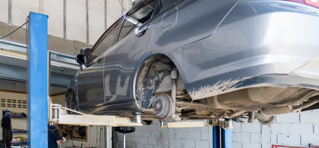 The car was lifted for change old brake car disc rotor, service new part vehicle at the garage.の写真素材