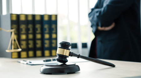 Gavel hammer, The woman lawyer is standing at the desk in the office with a justice scale. Study the law in business disputes to give advice to customers.の写真素材