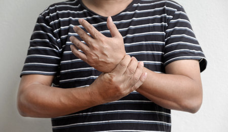 Man hand massage physiotherapy wrist is sore and numb, exhausted, tingling.の写真素材