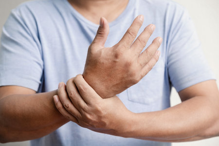 Man hand massage physiotherapy wrist is sore and numb, exhausted, tingling.の写真素材