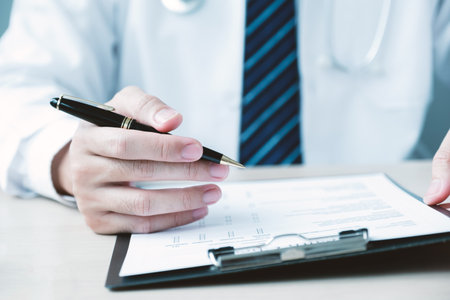 The doctor hand holding and pointing report, explained the health examination results to the patient, medical checkup concept.の写真素材