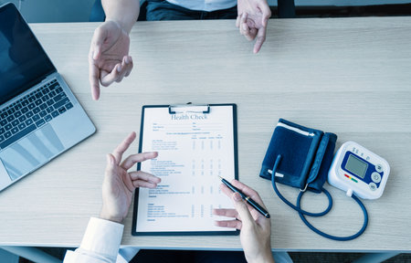 The doctor hand write report and explained the health examination results to the patient, medical checkup concept.の写真素材