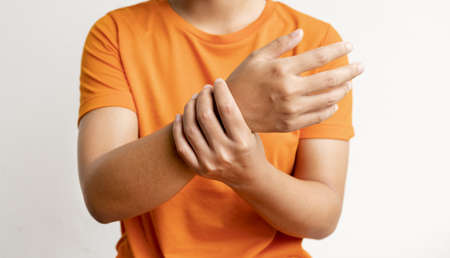 Woman hand massage physiotherapy wrist is sore and numb, exhausted, tingling. Guillain-Barre Syndrome, a side effect of the Covid vaccination.の写真素材
