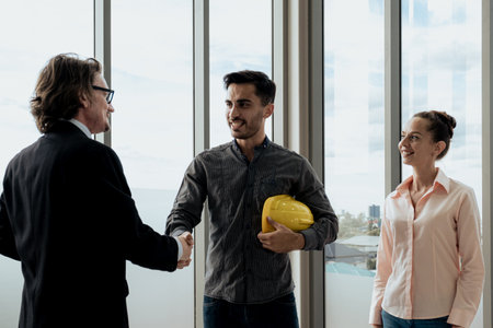 engineering team are Handshake and meeting to inspect the construction drawings, plan work and distribute work before starting the construction.の写真素材
