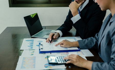 businessmen and businesswomen team meeting to plan strategies to increase business income. Have a brainstorming graph analysis and discussing for the new target successの写真素材