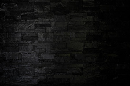 black background wall cladding stone pattern for modern house design a real stone wall.の写真素材