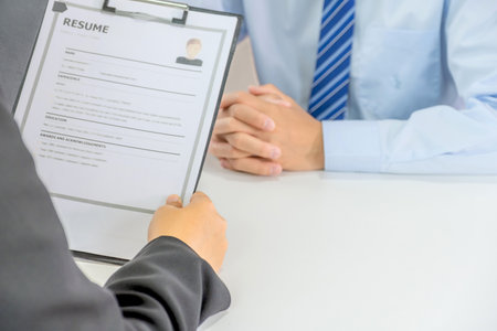 Office executives hand holding resume and interviewing job applicants in the meeting room. employer conversation summary work employment.の写真素材
