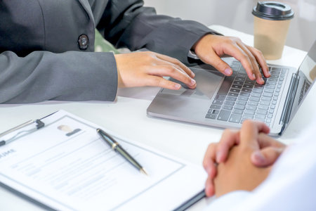 Office executives hand use laptop and interviewing job applicants in the meeting room. employer conversation summary work employment.の写真素材