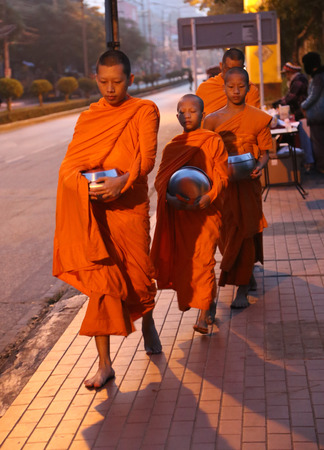 monks begging alms in the early morning in chiang mai ,thailandのeditorial素材