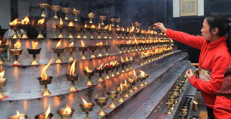 burning incense in a temple, chengdu, china
