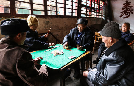 the old men playing cards in a teahouse, chengdu, china