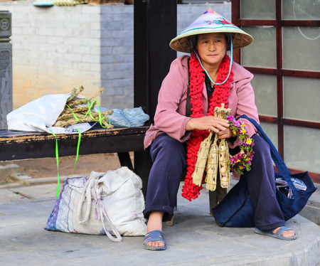 the woman selling eggs in hot sea park,tengchong,yunnan,chinaのeditorial素材
