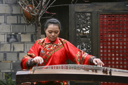 young woman playing the pipa in  kuanzhai alley , chengdu,chinaのeditorial素材