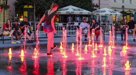 girl playing water at the fountain in the town, budapest, hungaryのeditorial素材