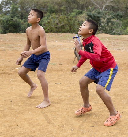 Laotian boys playing ball in wanrong,laosのeditorial素材