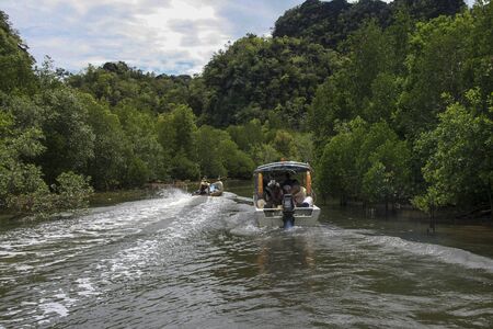 sightseeing boat in mangrove, langkawi, malaysiaの写真素材