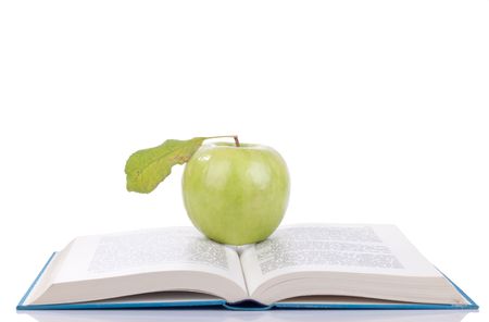 blue open book with green apple on it - isolated on  whiteの写真素材