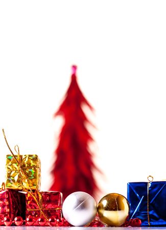 presents, xmas balls with red xmas tree in backgorundの写真素材