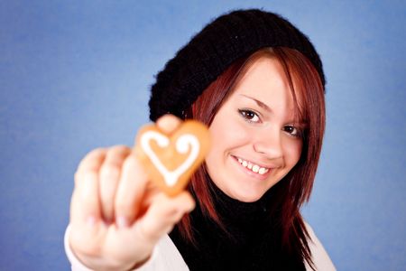 cute smiling girl with cookie in her handsの写真素材