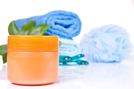 tube of cream with two folded towels blue rocks plant and spongeの写真素材