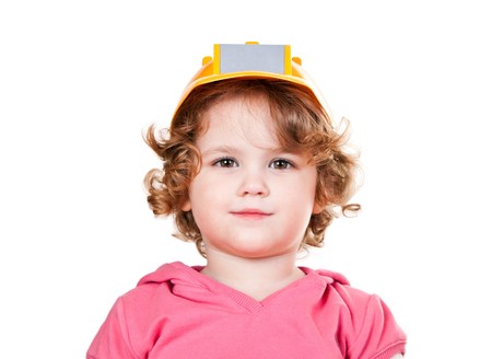 portrait of a cute little girl with yellow helmet on her headの写真素材