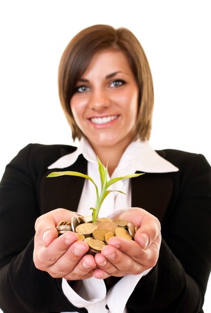 pretty young businesswoman holding a growing plant and coinsの写真素材