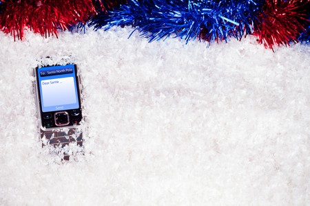 mobile phone with message to Santa in snow