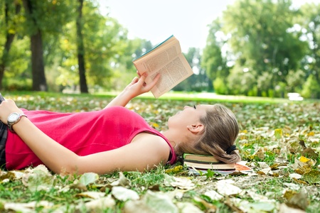 young woman relaxing and reading book