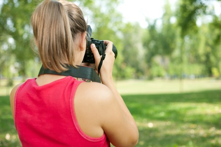 young girl taking picture on naturalの写真素材