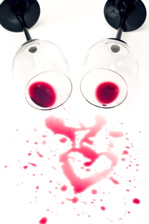 wine spilled from glasses forming heart shapeの写真素材