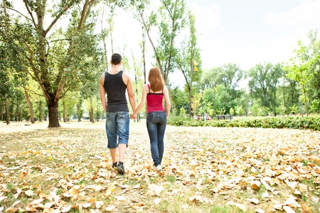 couple in love walking in autumn parkの写真素材