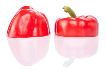 Red Peppers cut half-and-half with reflection, isolated on a white background
