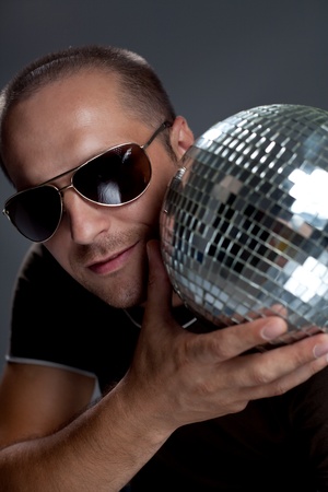 
handsome man with disco ball on dark backgroundの写真素材