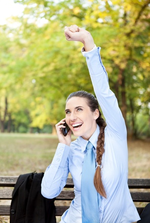 businesswoman happy for good news with raised armの写真素材