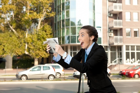 excited businesswoman with newspaper, excellent newsの写真素材