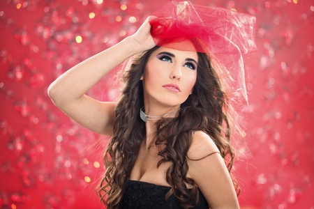 portrait of young woman with red scarf on  color backの写真素材