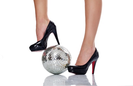 legs in black elegant high heel with disco ball, isolated on white backgroundの写真素材