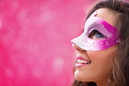 mysterious woman masquerading over red backgroundの写真素材