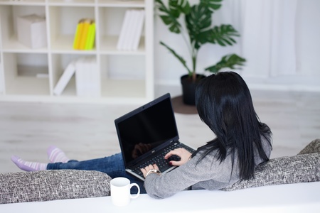 young girl with laptop computer, back viewの写真素材