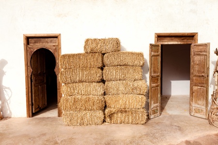 Old authentic Moroccan home with straw bales next wallの写真素材