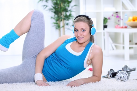 
Smiling young woman exercising at homeの写真素材