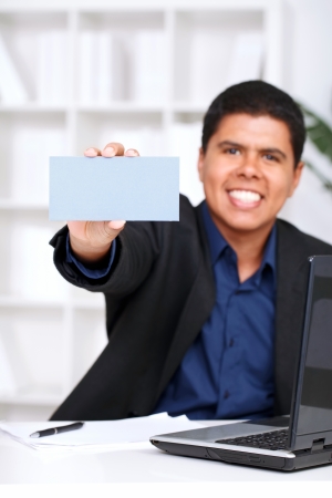 
businessman with blank business card in a hand in  office の写真素材