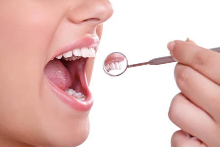 Beautiful healthy teeth with dental mirror