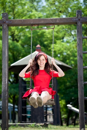 beautiful girl having a great time on a swingの写真素材