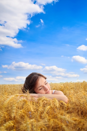 
Young pretty woman on yellow wheat fieldの写真素材